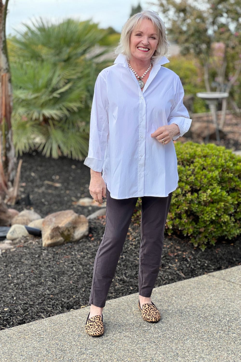 Jennifer Connolly wears an oversized white poplin shirt and Eileen Fisher pants with Birdie leopard shoes