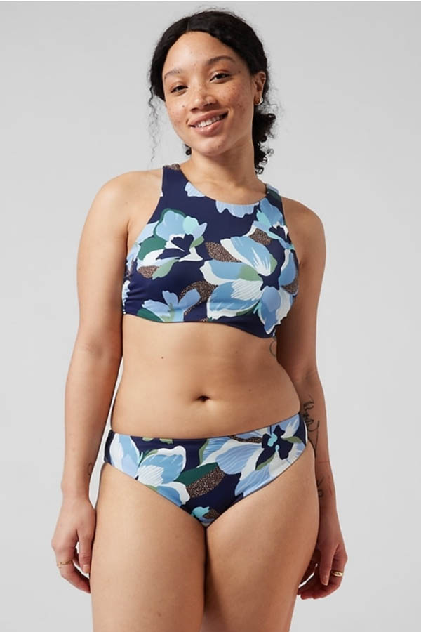 The model is wearing a two-piece print swimsuit by Athleta.