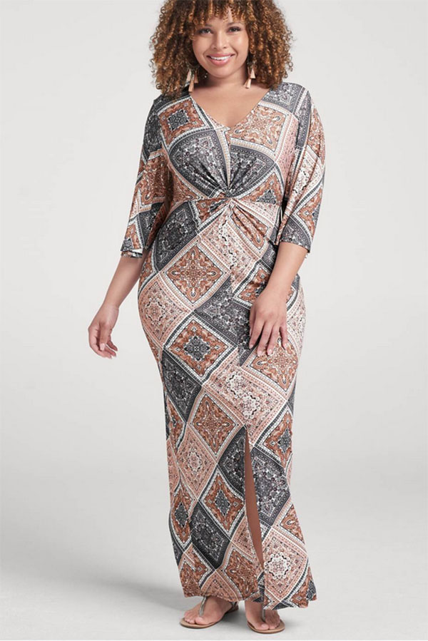 The model is wearing a plus size patterned maxi dress.