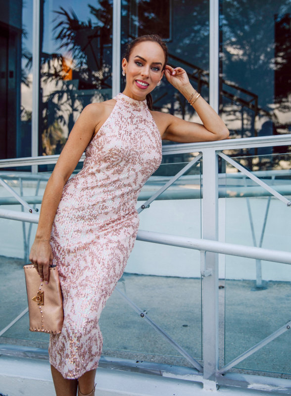 Sydne Style wears a show sequined midi dress with a slick ponytail back