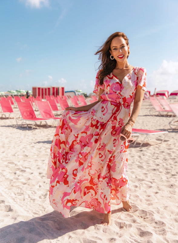 Sydne Style wears a pink and red printed maxi dress in Miami Beach.