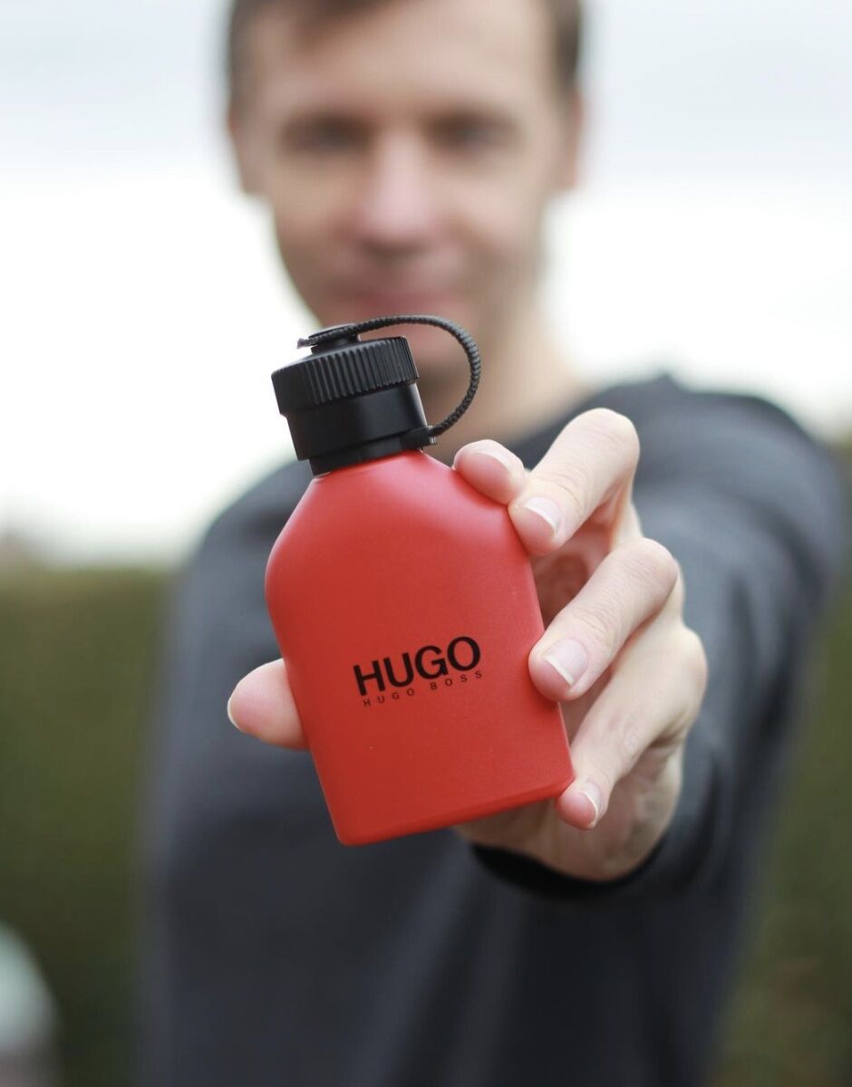 Man holding a bottle of Hugo Boss Cologne